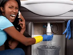Emergency plumbing repair for a leaking sink drain under a bathroom vanity in Memphis, TN