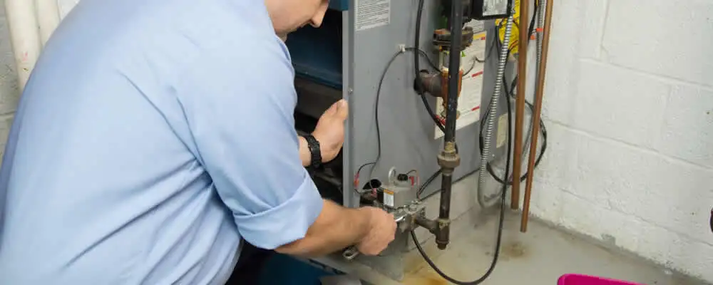 Furnace repair technician inspecting and servicing a home heating system in Memphis, TN