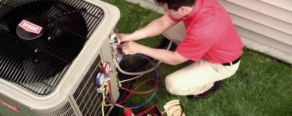 HVAC technician servicing an outdoor air conditioner unit in Memphis, TN