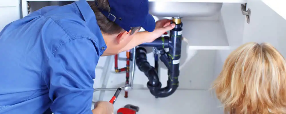 Plumber repairing under-sink drain pipes and fittings in Memphis, TN